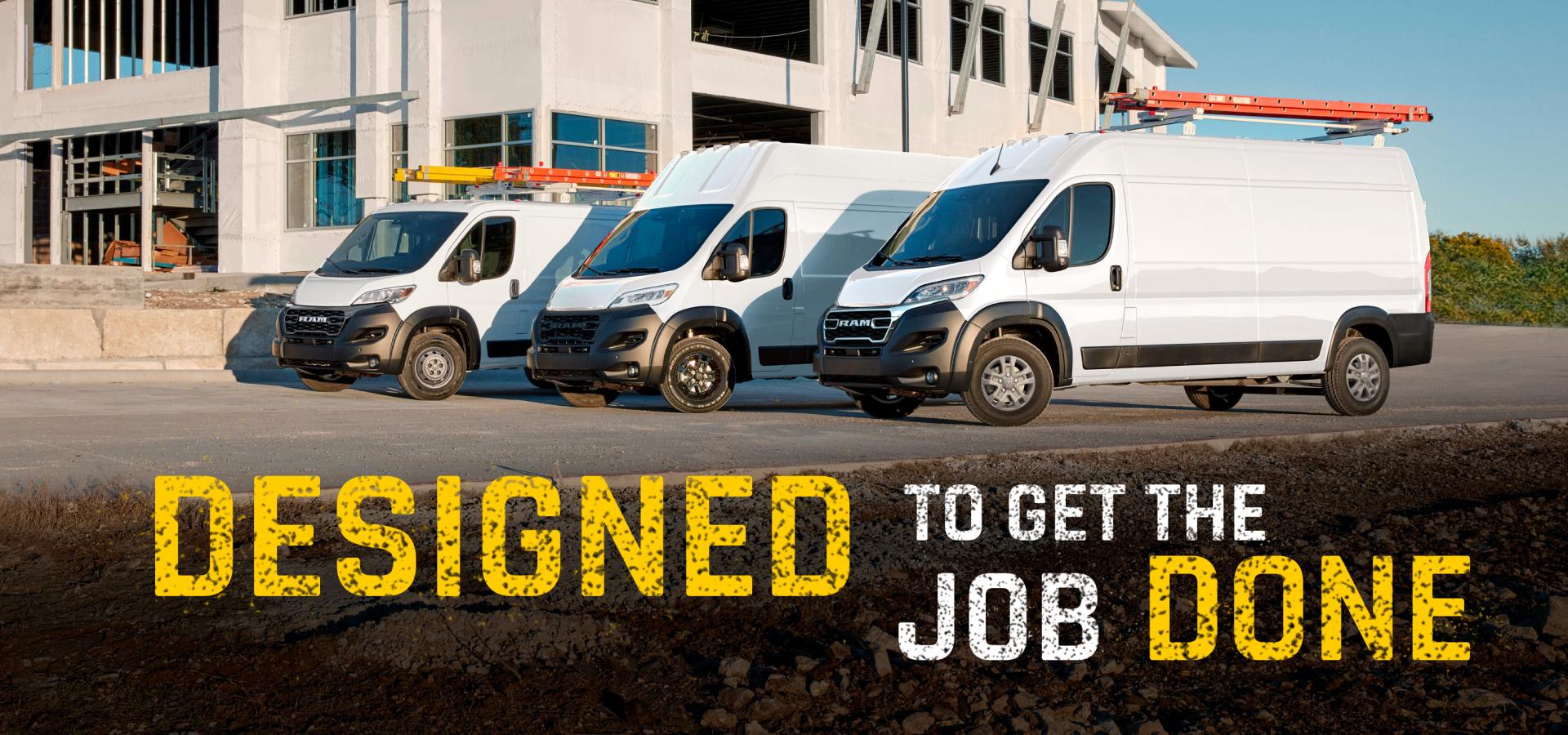 A lineup of three white 2027 Ram ProMaster vans parked at a construction site: from left to right, a Ram ProMaster 1500 Tradesman Standard Roof Cargo Van, a Ram ProMaster 3500 SLT Plus Super High Roof Cargo Van with the Black Appearance Package, and a Ram ProMaster 3500 SLT High Roof Cargo Van. Designed To Get The Job Done.