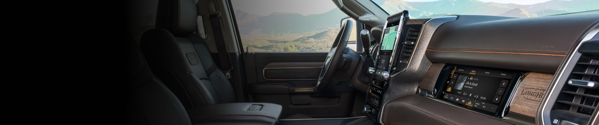 The steering wheel, Uconnect touchscreen and Front Passenger Interactive Display in the 2026 Ram 2500 Limited Longhorn.